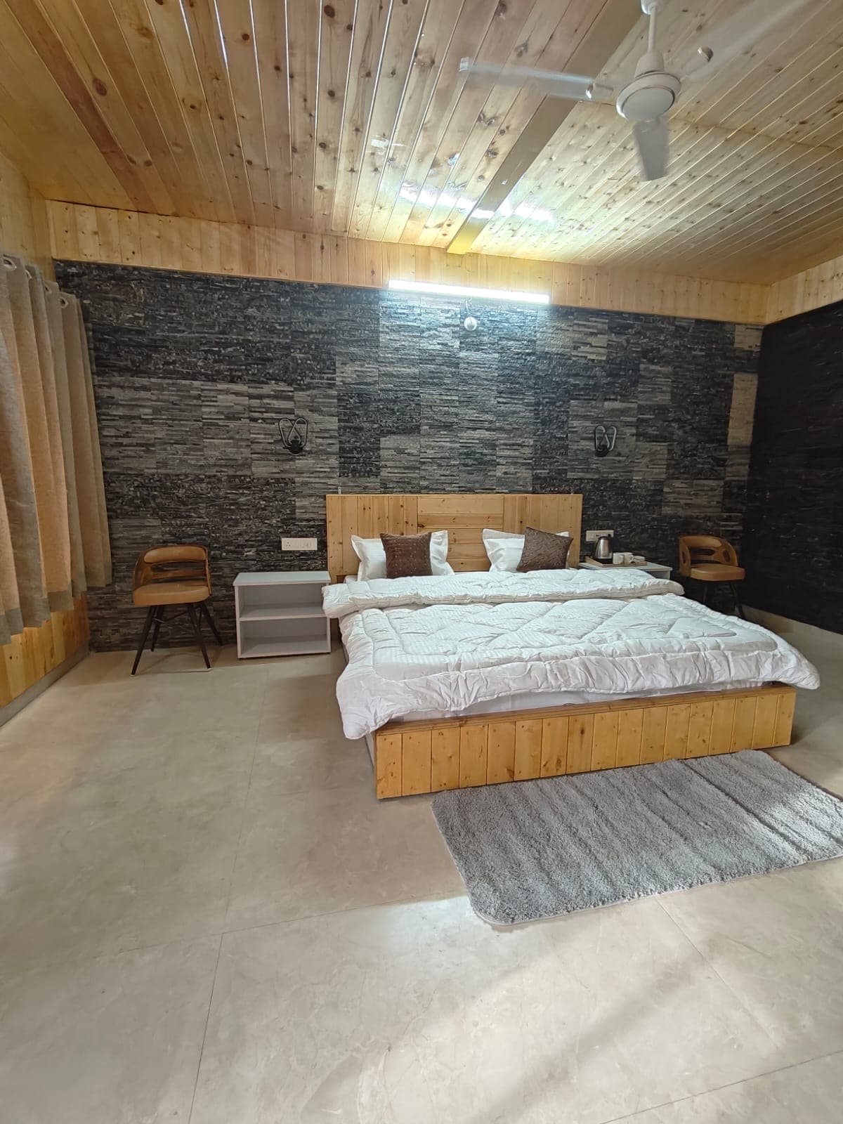 Stone-and-wood bedroom at The Baan.
